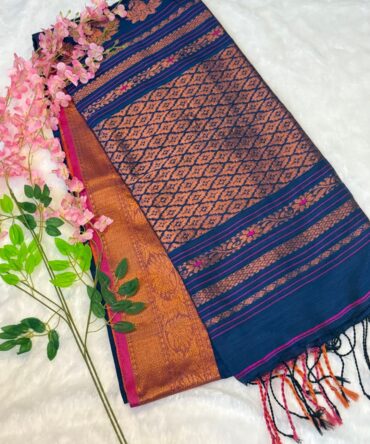 The rich Blue hue provides a stunning backdrop for the shimmering gold work, meticulously woven into traditional border. Every thread tells a story of the weaver's skill, making this saree a timeless collectible that is both lightweight and grand—perfect for cultural events, festivals, and weddings.